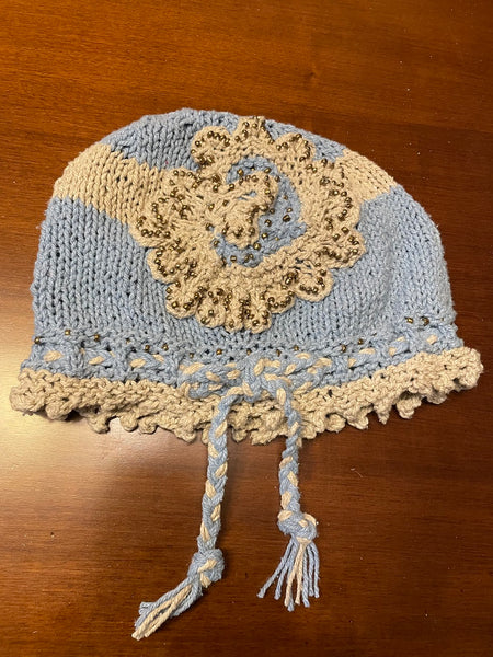 Knitted cotton and silk beanie in light blue with beige embellished flower and gold seed beads